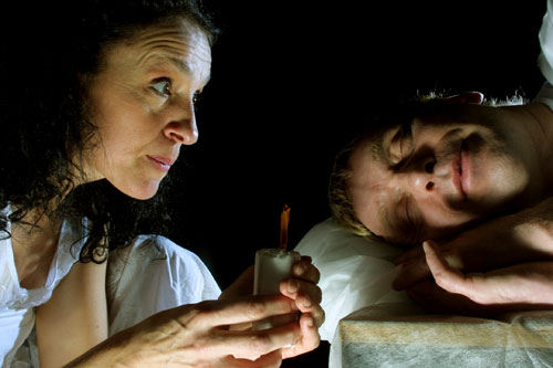 The girl looks at the Prince by candlelight